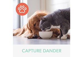 Dog and cat eating out of the same bowl. Below, are the words "Capture Dander"